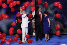 Democratic presidential nominee Hillary Clinton taps balloons as they fall around her, Former President Bill Clinton, Democratic vice presidential nominee Sen. Tim Kaine, D-Va., and Kanie's wife Anne Holton during the final day of the Democratic National Convention in Philadelphia , Thursday, July 28, 2016. AP Photo/J. Scott Applewhite