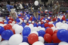 A worker at the Wells Fargo arena pop balloons at the end of the final day of the Democratic National Convention, Friday, July 29, 2016, in Philadelphia. AP Photo/Mary Altaffer