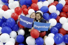 Campaign staffers for Democratic presidential nominee Hillary Clinton pose in balloons on the floor after the Democratic National Convention in Philadelphia, Thursday, July 28, 2016. AP Photo/Paul Sancya
