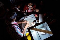 Children buy a traditional snack called cilok (meatballs) at the Five Mountain Festival on July 24. JP/Albertus Magnus Kus Hendratmo