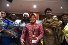 Surabaya Mayor Tri Rismaharini is all smiles during a meeting with her fellow female mayors who are participants of PreCon III UN-Habitat during a meeting of Asia Pacific Mayors in Surabaya, East Java on July 24. She has just inaugurated the opening of Rumah Matematika (House of Mathematics), which is designated for elementary and junior high school students in Surabaya, East Java, on Thursday.