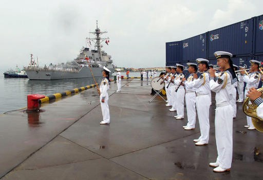 A Chinese military band plays as the guided missile destroyer USS Benfold arrives in port in Qingdao in eastern China's Shandong Province, Aug. 8. 