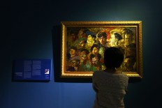 A visitor enjoys a work at the National Gallery on Aug. 2. The Jakarta Post/Wienda Parwitasari
