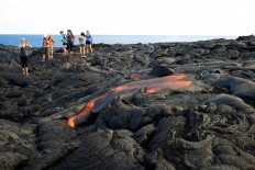 Lava from Hawaii volcano cascades into sea in vivid display 