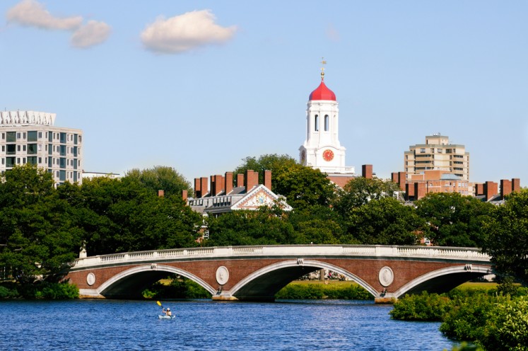 View of Harvard University and pedestrian bridge on Charles River, Cambridge, Massachusetts.