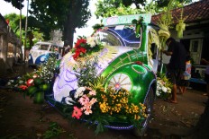A pedal car is decorated like a wedding car for the carnival. JP/ Aditya Sagita