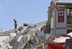 Rescuers work in Amatrice, central Italy, Wednesday, Aug. 24, 2016, where a magnitude 6 quake struck at 3:36 a.m. [0136 GMT] and was felt across a broad swath of central Italy, including Rome where residents of the capital felt a long swaying followed by aftershocks. Turistic sign at right reads in Italian : "Amatrice, one of the most beautiful hamlets in Italy". AP Photo/Alessandra Tarantino