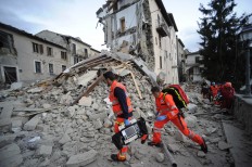 Rescuers search a crumbled building in Arcuata del Tronto, central Italy, where a 6.1 earthquake struck just after 3:30 a.m., Wednesday, Aug. 24, 2016. The quake was felt across a broad section of central Italy, including the capital Rome where people 
in homes in the historic center felt a long swaying followed by aftershocks. AP Photo/Sandro Perozzi