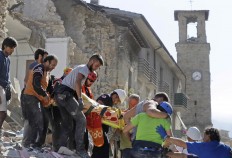 A victim is carried on a stretcher from a collapsed building after an earthquake, in Amatrice, central Italy, Wednesday, Aug. 24, 2016. A devastating earthquake rocked central Italy early Wednesday, collapsing homes on top of residents as they slept. At least 23 people were reported dead in three hard-hit towns where rescue crews raced to dig survivors out of the rubble,  but the toll was expected to rise as crews reached homes in more remote hamlets. AP Photo/Alessandra Tarantino

