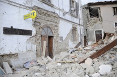 A post office is engulfed by rubbles in Arcuata del Tronto, central Italy, where a 6.1 earthquake struck just after 3:30 a.m., Wednesday, Aug. 24, 2016. The quake was felt across a broad section of central Italy, including the capital Rome where people in homes in the historic center felt a long swaying followed by aftershocks. AP Photo/Sandro Perozzi