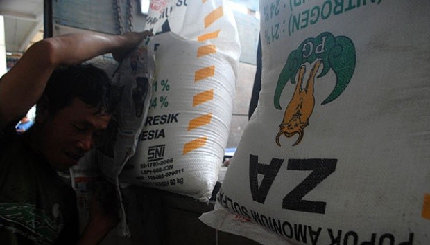 A worker moves bags of subsidized fertilizers to be distributed to retailers.