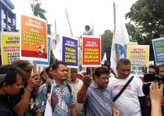 Workers urge court to annul Tax Amnesty Law