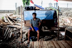 Rachman, 27, lives alone in his shack, Pejagalan, Jakarta, August 2016. He has lived there since 2007. He sent her wife back to his hometown in Sumatra since the eviction. He was a parking attendant before but with the business in Kalijodo gone he now works odd jobs, if there is any. JP/Seto Wardhana