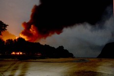 A fire burns amid a social conflict over possible gold mining on the island. JP/Tarko Sudiarno