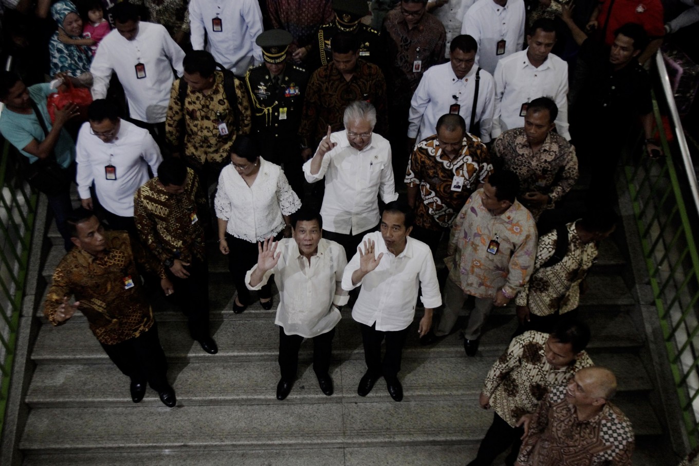 Philippines' President Rodrigo Duterte, center left, waves with his Indonesian counterpart Joko Widodo during their visit at Tanah Abang Market on the sidelines of their meeting in Jakarta on Sept. 9. Duterte is currently on a two-day visit to the country. 