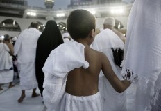 A child holds on to his father as he circles the Kaaba, Islam's holiest shrine, at the Grand Mosque in the Muslim holy city of Mecca, Saudi Arabia, Thursday, Sept. 8, 2016. Muslim pilgrims have begun arriving at the holiest sites in Islam ahead of the annual hajj pilgrimage in Saudi Arabia, with some weeping with their hands outstretched for a fleeting touch of the Kaaba. The cube-shaped shrine, at the center of Mecca's Grand Mosque, is the site the world’s 1.6 billion Muslims pray toward five times a day. AP Photo/Nariman El-Mofty