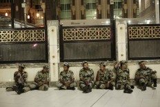 Saudi security rest before praying the Fajr, prayer before sunrise, outside the Grand Mosque in the Muslim holy city of Mecca, Saudi Arabia, Thursday, Sept. 8, 2016. Muslim pilgrims have begun arriving at the holiest sites in Islam ahead of the annual hajj pilgrimage in Saudi Arabia, with some weeping with their hands outstretched for a fleeting touch of the Kaaba. The cube-shaped shrine, at the center of Mecca's Grand Mosque, is the site the world’s 1.6 billion Muslims pray toward five times a day. AP Photo/Nariman El-Mofty
