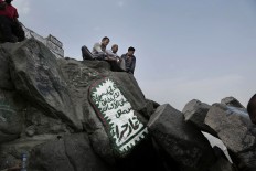 Turkish men visit Hiraa cave on Noor Mountain, where Prophet Muhammad received his first revelation from God to preach Islam, on the outskirts of Mecca, Saudi Arabia, Friday, Sept. 9, 2016. Muslim pilgrims have begun arriving at the holiest sites in Islam ahead of the annual hajj pilgrimage in Saudi Arabia. AP Photo/Nariman El-Mofty