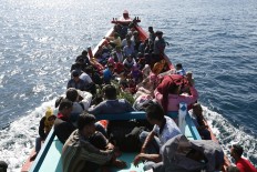 Passengers ride a boat from Breuh Island to the mainland of Banda Aceh on Sept. 10. The number of travelers among islands around Aceh increased prior to Idul Adha [the Islamic Day of Sacrifice], celebrated on Sept. 12. JP/ Hotli Simanjuntak