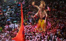 Hindu devotees participate in a procession towards the Arabian Sea where a giant idol of the elephant-headed god Ganesha will be immersed on the final day of the ten-day long Ganesha Chaturthi festival in Mumbai, India, Thursday, Sept. 15, 2016 . The last day of the 10-day celebration is the biggest day, with massive crowds singing and dancing as they carry their idols through the streets, to immerse them in the water, an act that symbolizes sending the god back to his mythical home in the snow-capped mountains taking all the worries and problems of his worshippers with him. AP Photo/Rafiq Maqbool