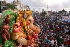 A huge idol of elephant-headed Hindu god Ganesha is taken on a truck in a procession before immersing in the Hussain Sagar Lake on the final day of the festival of Ganesh Chaturthi in Hyderabad, India, Thursday, Sept. 15, 2016. The immersion marks the end of the ten-day long festival that celebrates the birth of the Hindu god. AP Photo/Mahesh Kumar A.