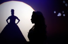 In this Sunday, Sept. 18, 2016 photo, Britanie Eichenholc, from France, right, is seen silhouetted during her performance at the Miss Trans Star International 2016 show celebrated in Barcelona, Spain.