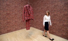 A woman looks towards part of an artwork called 'Lichen! Libido! [London!] Chastity!' by Anthea Hamilton, one of the four artists shortlisted for the Turner Prize 2016, as it is displayed at the Tate Britain gallery in London, Monday, Sept. 26, 2016. The Turner Prize aims to promote public debate around new developments in contemporary British art. AP Photo/Kirsty Wigglesworth