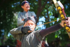 A participant aims for his target in Jemparingan at Taman Sriwedari in Surakarta, Central Java.  JP/ Ganug Nugroho Adi