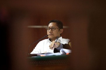 Former Democratic Party chairman Anas Urbaningrum attends a hearing at the Jakarta Corruption Court on Aug. 11, 2014.