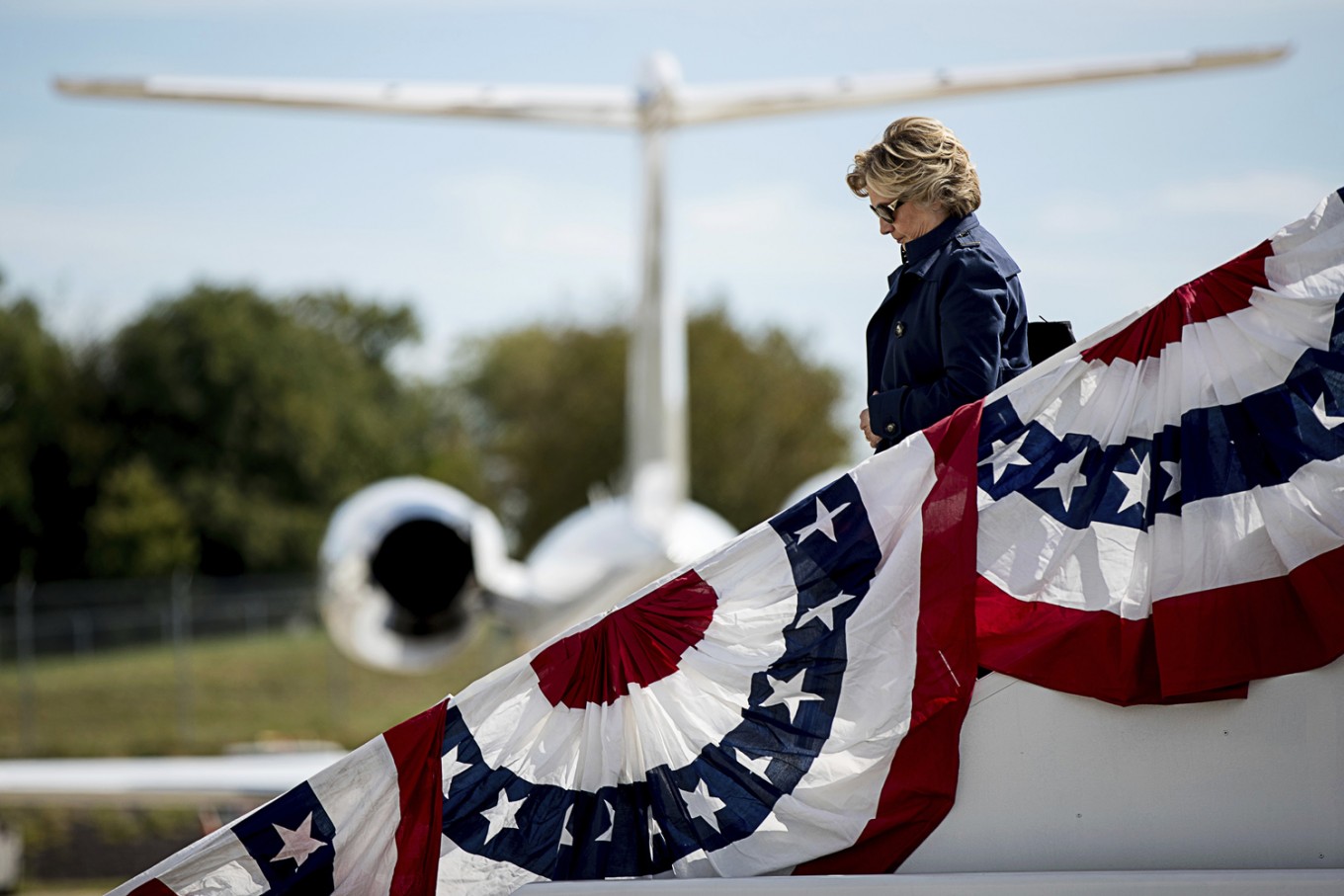 All set -- Democratic presidential candidate Hillary Clinton arrives at Lambert–St. Louis International Airport in St. Louis, Sunday, Oct. 9, 2016, for the second presidential debate. 
