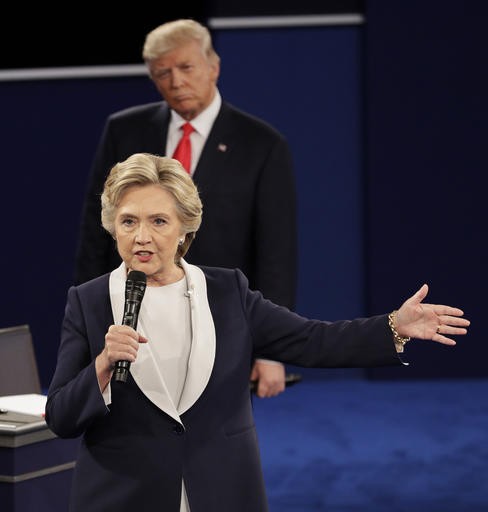 Republican presidential nominee Donald Trump listens to Democratic presidential nominee Hillary Clinton during the second presidential debate at Washington University in St. Louis, Oct. 9, 2016. 