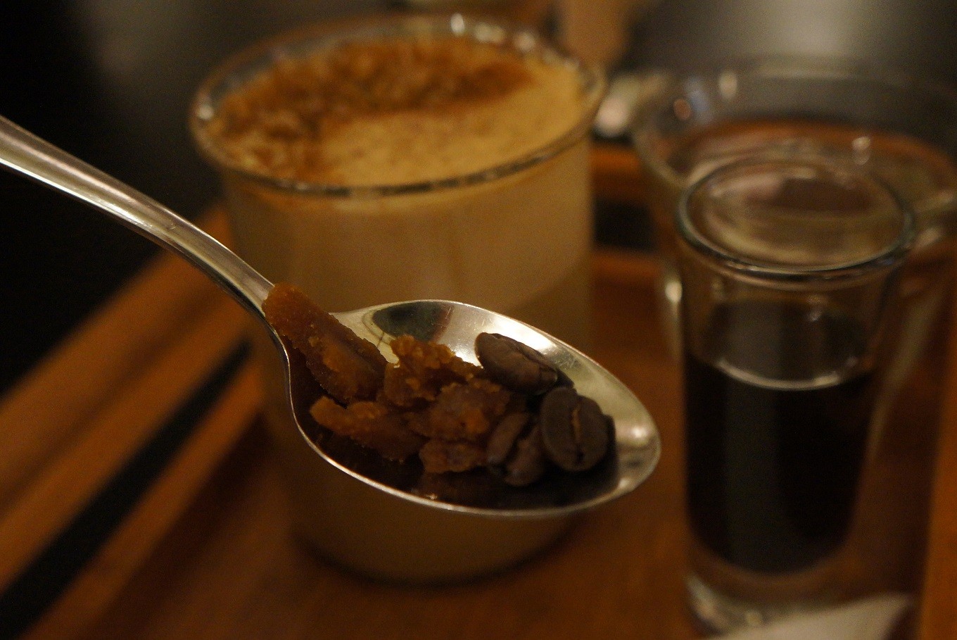 Coconut latte and a spoonful of kopi kertup at Benedict restaurant in Grand Indonesia, Central Jakarta.