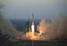 In this photo provided by China's Xinhua News Agency, the Long March-2F carrier rocket carrying China's Shenzhou 11 spacecraft blasts off from the launch pad at the Jiuquan Satellite Launch Center in Jiuquan, northwest China's Gansu Province, Monday, Oct. 17, 2016. 