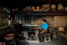 A woman roasts coffee beans at Bali Pulina in Tegalalang, Bali. The agrotourism center is widely known in Bali as a place to enjoy luwak coffee. JP/Agung Parameswara