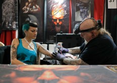 In this picture taken on Sunday, Oct. 16, 2016, Paul Booth of the U.S., one of the world's most famous tattoo artists, works during the International Tattoo Convention Bucharest 2016 in Bucharest, Romania. More than 100 tattoo and piercing artists brought their skills and art to a three-day convention in the Romanian capital. AP Photo/Vadim Ghirda
