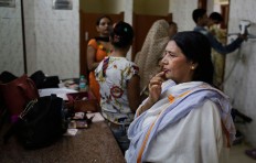 An Indian Hindu widow touches her lips after a make-up artist applied lipstick on it before a fashion show in New Delhi, India, Saturday, Oct. 15, 2016. In most of India, millions of Hindu widows are expected to live out their days in quiet worship, dressed only in white, typically barred from all religious festivities because their very presence is considered inauspicious. But slowly, widows are moving toward modernity. Their lives appear to be changing for better with women's groups and Indian aid organizations taking interest in their welfare. AP Photo/Altaf Qadri