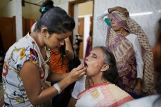 A makeup artist applies lipstick on an Indian Hindu widow before a fashion show in New Delhi, India, Saturday, Oct. 15, 2016. In most of India, millions of Hindu widows are expected to live out their days in quiet worship, dressed only in white. They are typically barred from all religious festivities because their very presence is considered inauspicious. Their lives appear to be changing for better with women's groups and Indian aid organizations taking interest in their welfare. AP Photo/Altaf Qadri