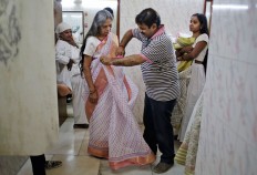 An Indian Hindu widow gets dressed backstage before participating in a fashion show in New Delhi, India, Saturday, Oct. 15, 2016. In most of India, millions of Hindu widows are expected to live out their days in quiet worship, dressed only in white. They are typically barred from all religious festivities because their very presence is considered inauspicious. Their lives appear to be changing for better with women's groups and Indian aid organizations taking interest in their welfare. AP Photo/Altaf Qadri
