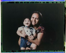 In this Sept. 29, 2016 photo made from a negative recovered from instant film, Rozilene Ferreira poses with her 1-year-old son, Arthur Conceicao, who was born with microcephaly, one of many serious medical problems that can be caused by congenital Zika syndrome, in Recife, Pernambuco state, Brazil. A year after a spike in the number of newborns with the defect known as microcephaly, Brazilian doctors and researchers have seen many of the babies develop swallowing difficulties, epileptic seizures and vision and hearing problems. AP Photo/Felipe Dana
