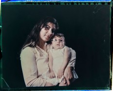 In this Sept. 29, 2016 photo made from a negative recovered from instant film, Jusikelly da Silva poses for a photo with her daughter Luhandra, who was born with microcephaly, one of many serious medical problems that can be caused by congenital Zika syndrome, in Recife, Pernambuco state, Brazil. Silva says she is desperate to get a brain scan for Luhandra, who was sitting up and eating solid foods before a seizure several months ago left her virtually motionless. AP Photo/Felipe Dana
