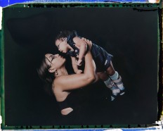 In this Sept. 29, 2016 photo made from a negative recovered from instant film, Rosana Alves holds her daughter Luana, who was born with microcephaly, one of many serious medical problems that can be caused by congenital Zika syndrome, as they pose for a photo in Recife, Pernambuco state, Brazil. Alves has three daughters and has left work to take care of Luana, who is equipped with specially designed leg braces to help position her feet. AP Photo/Felipe Dana