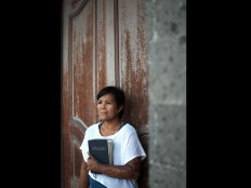 Yayuk on July 2, 2012 posing with a Bible. She converted to Christianity from Islam after the bombing. JP/ Anggara Mahendra