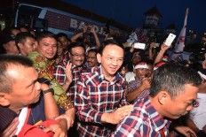 Ahok spends first day leave taking son to university