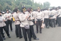 Members of the women's officer corps are on standby at the National Monument (Monas) complex in Central Jakarta on Nov. 4, 2016.