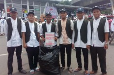 Students collect garbage left by protesters