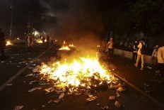 Jakarta cools off after violent rally