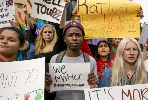 Protestors (from left) Celeste Ramirez, 20, Erin Ckodre , 21, Ronald Elliott, 18, Patricia Romo, 22, and Rose Ammons, 18, hold up signs at Texas State University in San Marcos, Texas, Thursday Nov. 10, 2016, opposition of Donald Trump's presidential election victory. 