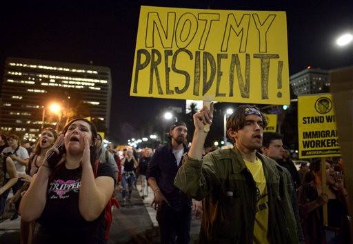 Protesters march through downtown along Spring Street during a protest against President-elect, Donald Trump, Wednesday, Nov. 9, 2016 in Los Angeles. 