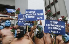 Nude students, Filipino activists protest dictator's burial