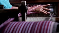 The hand of a worker during the warping process. JP/Aditya Sagita